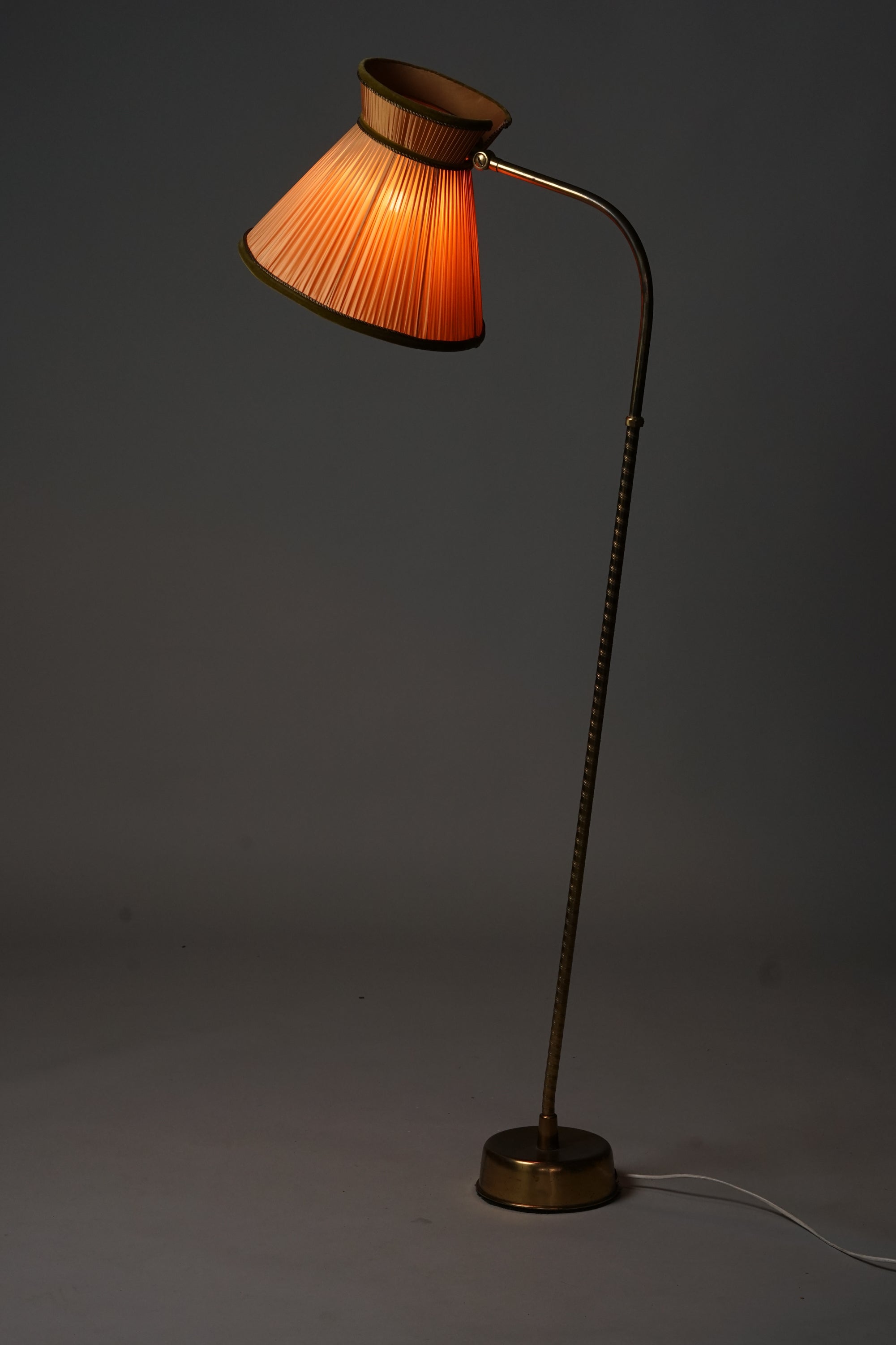 Floor lamp with brass frame. 
Lampshade is burnt orange pleated fabric with forest green velvet edging.